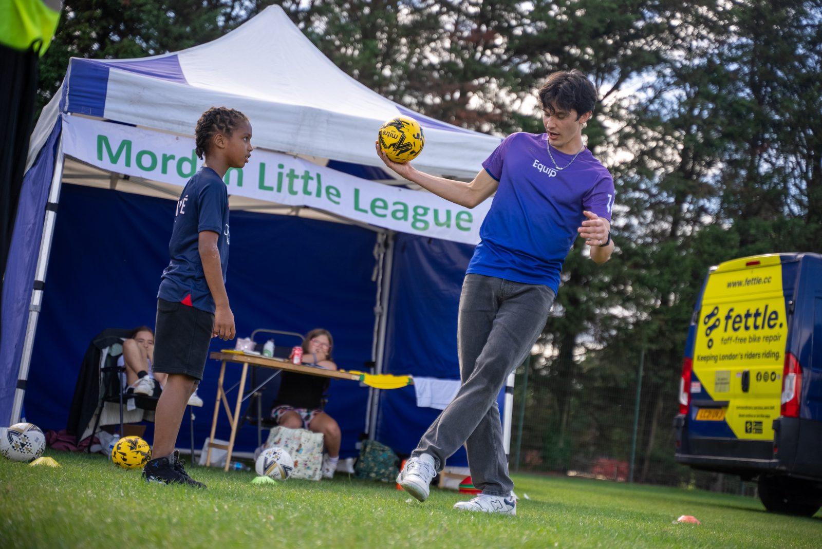 Coaching at the Morden Little League tent, in Equip purple