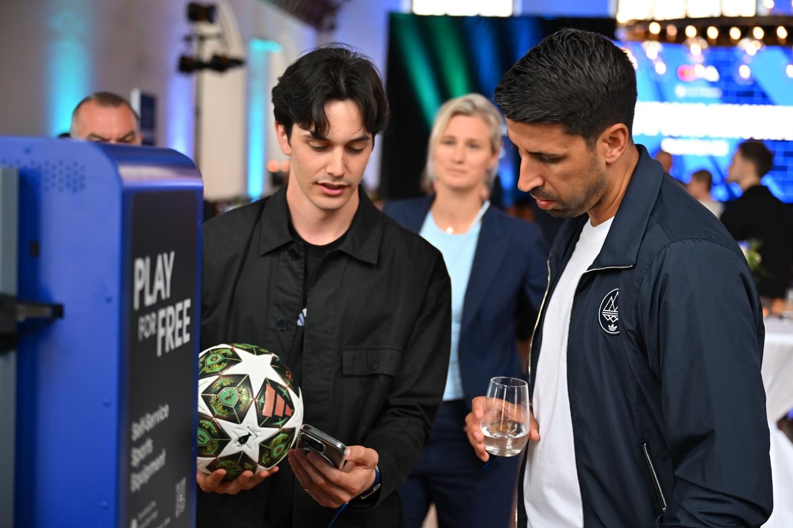 Oscar holding a Champions League ball at the Fan Zone
