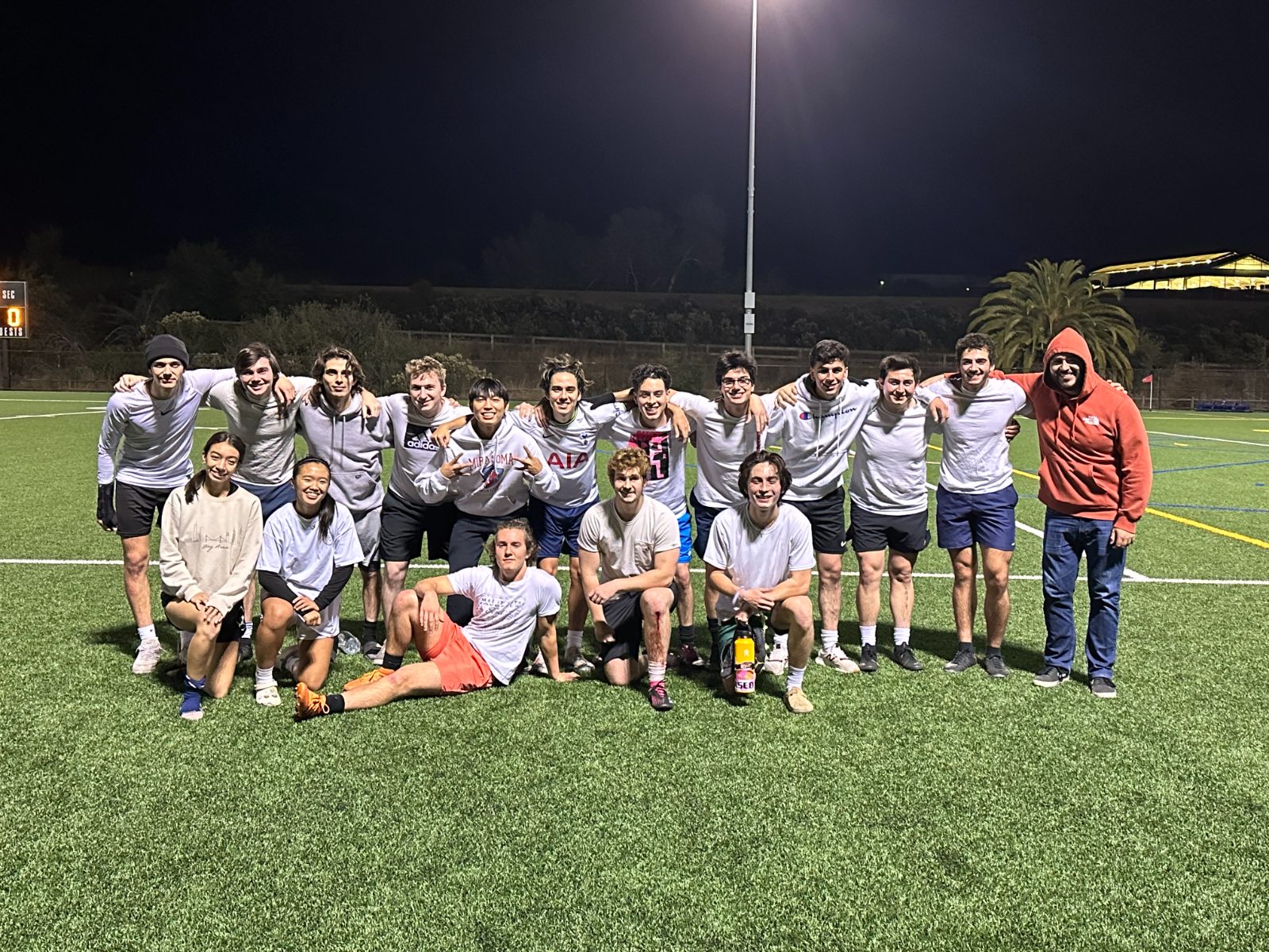 Pick-up team group photo on a floodlit night pitch